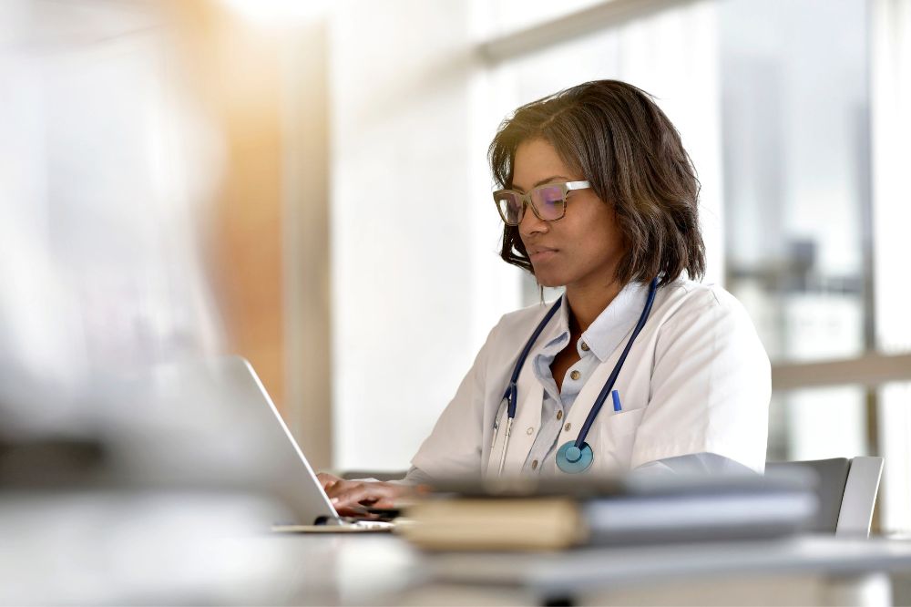medical practitioner working on a laptop